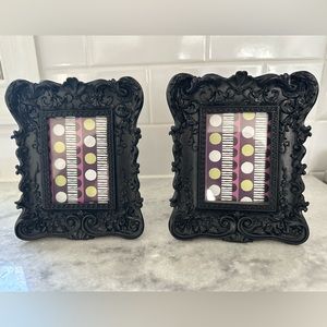 Brand new, unused pair of black picture frames with decorative molding.